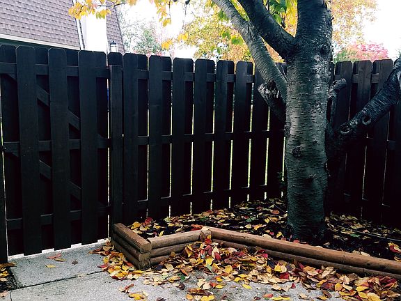 Fenced in patio with planter
