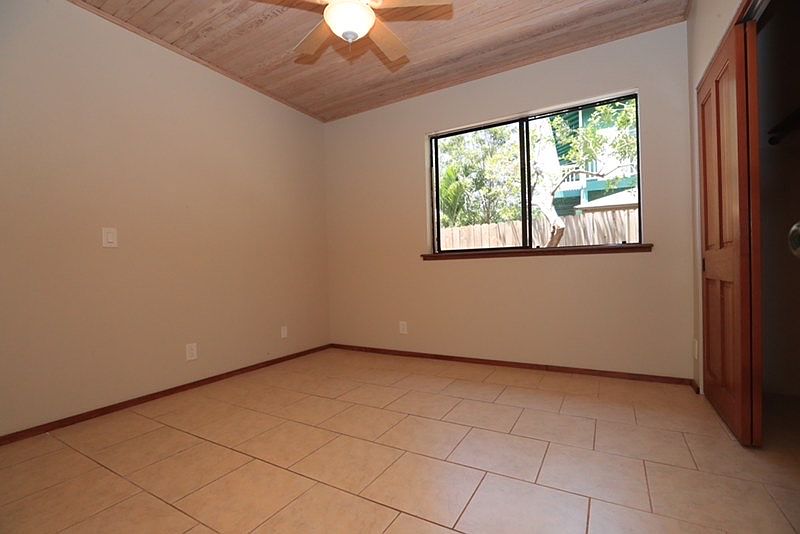 Tiled bedroom, cool, ceiling fan. Directly across the hall from the bathroom.