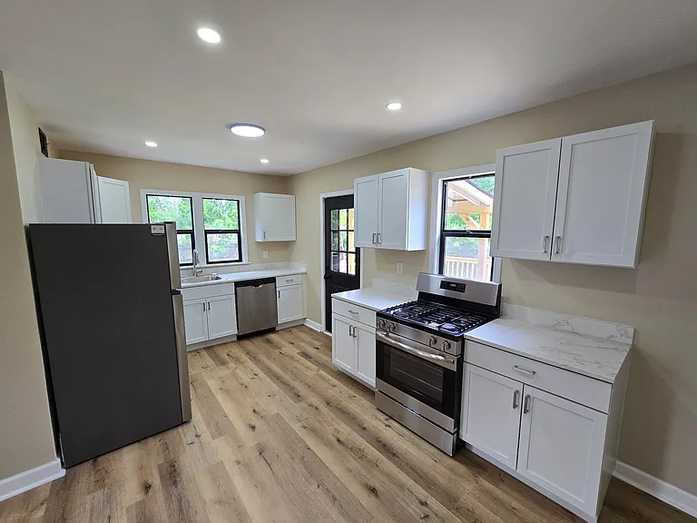 Brand new kitchen with stainless steel appliances, soft close cabinets, and upgraded lighting.