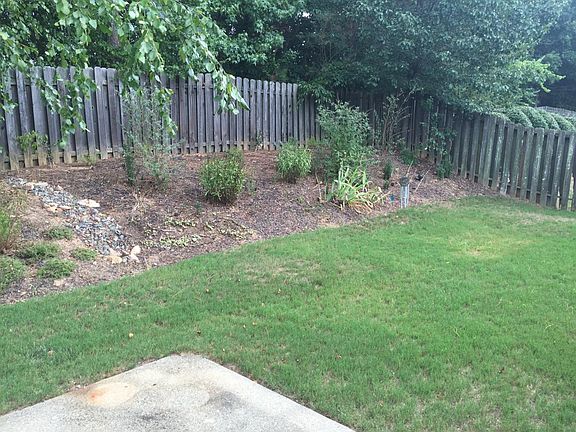Fenced Flat Backyard with Patio
