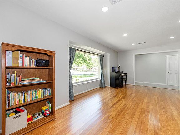 Bamboo floors, No Carpet! Recessed LED lights. Huge double paned window. View of living room looking toward entry with coat closet.