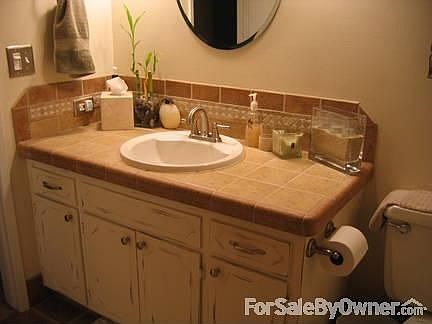 Main Bathroom : Earth tone tile in the main bathroom with new sink, bathtub, floor tile, etc.