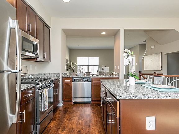 Beautiful, gourmet kitchens featuring granite, stainless steel appliances including gas range