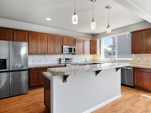 Modern kitchen with newer LG appliances and granite countertops