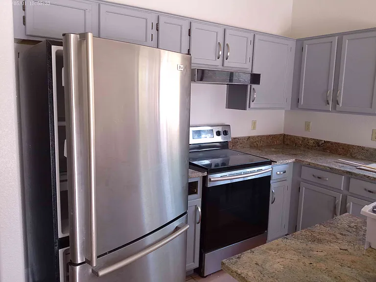 Kitchen fridge, stove, cabinets