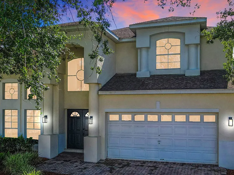 Behold the magnificent exterior of our DisneyEstate! The backyard offers stunning views of your private pool, championship golf course, and resort clubhouse with incredible amenities like Lap Pool, Pickleball, Tennis, and Children's Playground.