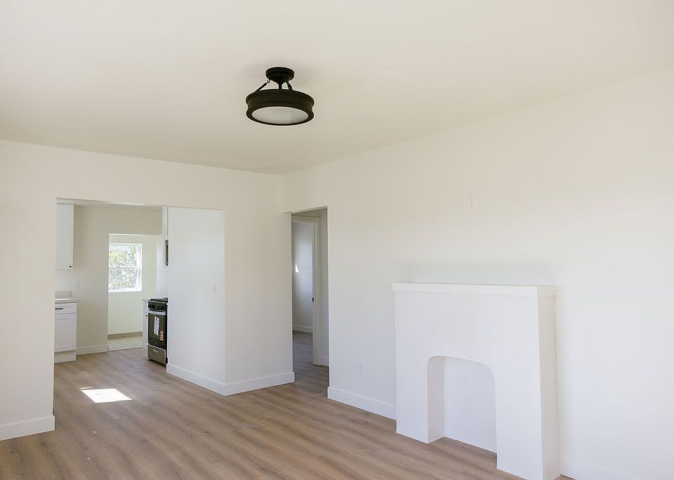 Living Room facing kitchen and bedrooms