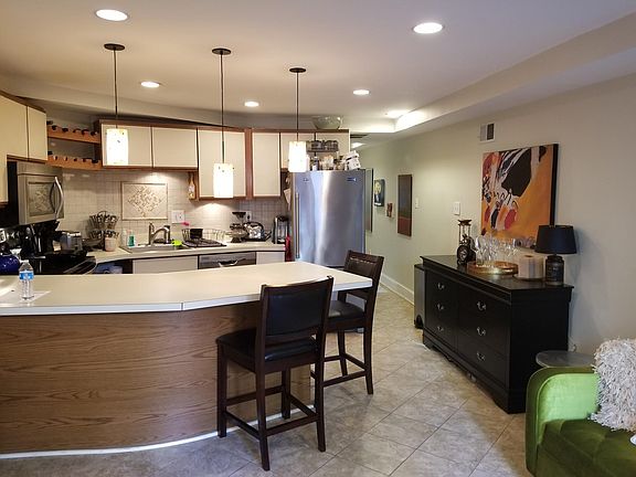 Open kitchen space with breakfast bar/cabinets