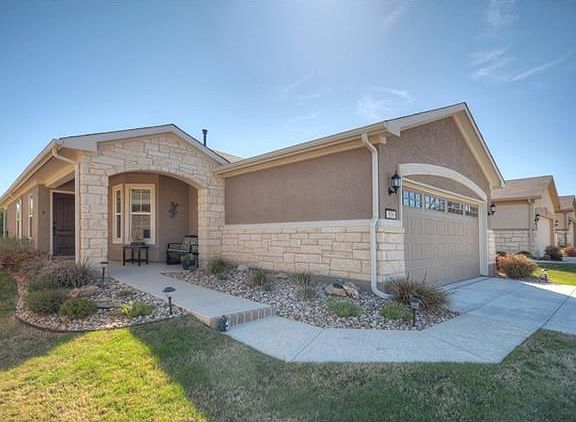 Nestled against a woodsy nature preserve, this beautiful Sun City Texas Gray Myst offers gorgeous wo