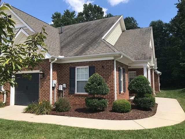 End unit with attached garage and side entrance.