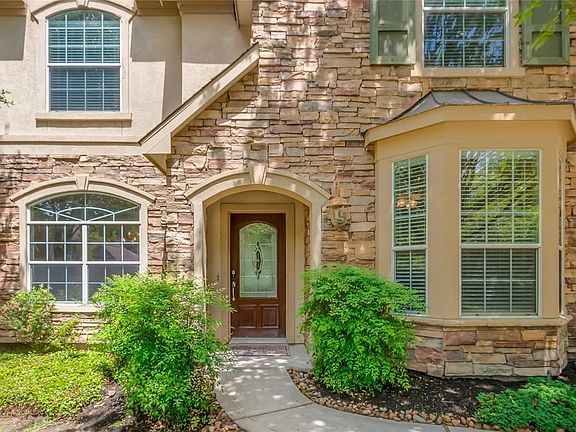 Stacked stone elevation and arched stone encased windows exudes curb appeal