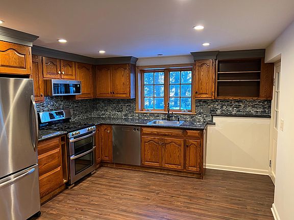 Open layout kitchen with microwave/fan over the oven.