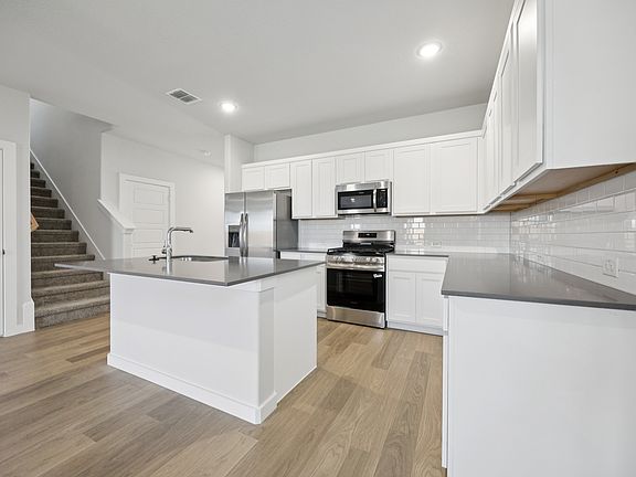 Kitchen in the Haylee home plan by Trophy Signature Homes - REPRESENTATIVE PHOTO