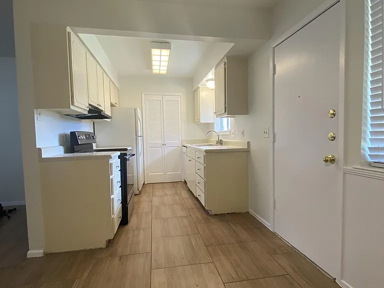 Kitchen and door to side yard patio (alternative private entry to house)