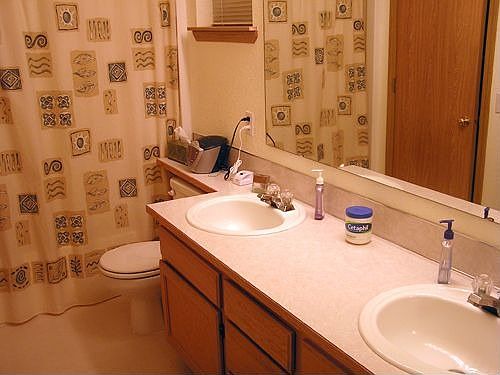 master bath with double sinks and large closet