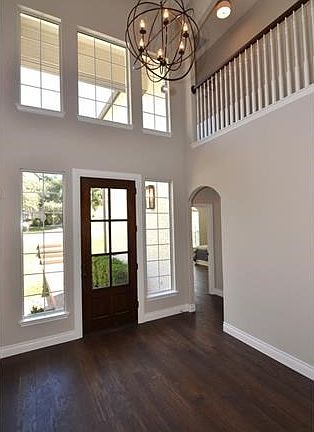 Grand entry with wood floors and orb lighting