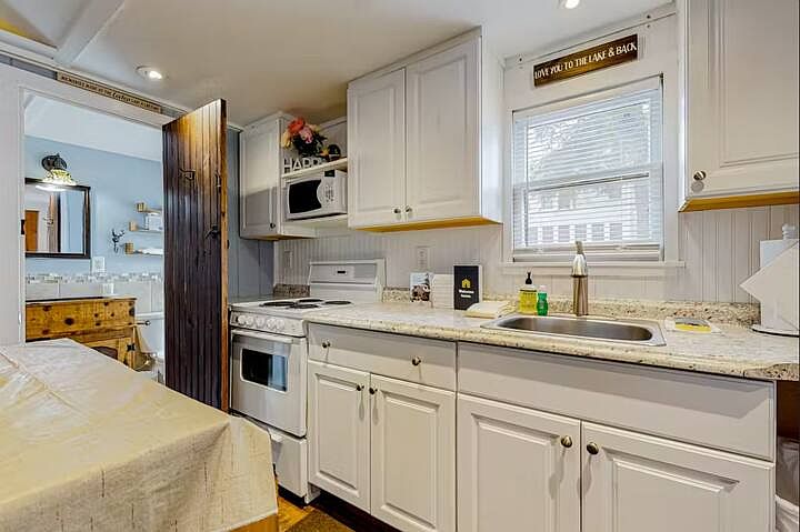 Full kitchen with Oven, micro, large counter and sink area, lots or storage