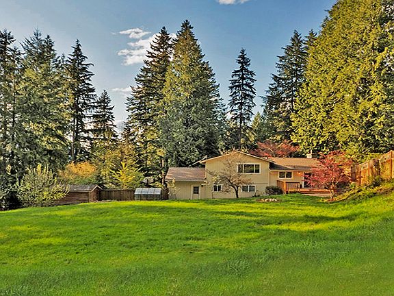 Wowâ?¦.a wonderful backyard with fruit trees to the left, a garden shed, greenhouse, and the rear of