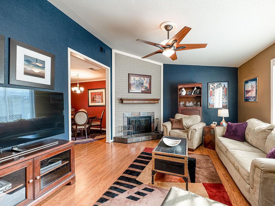 Beautiful living room with natural lighting, hard floors, and cozy space for hosting.