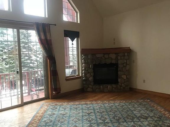 Living room with gas fireplace and cathedral ceilings