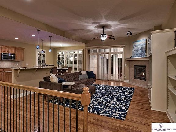 open floor plan, with hardwood floors through the area and into the kitchen