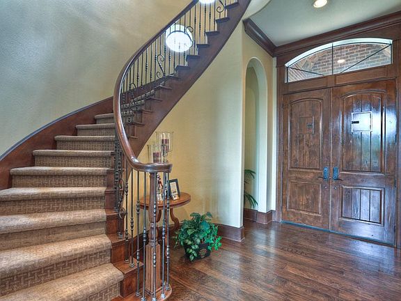 The sweeping front staircase graces the impressive entry to this grand home.  Knotty alder doors and extensive custom millwork give this home a rich warmth.