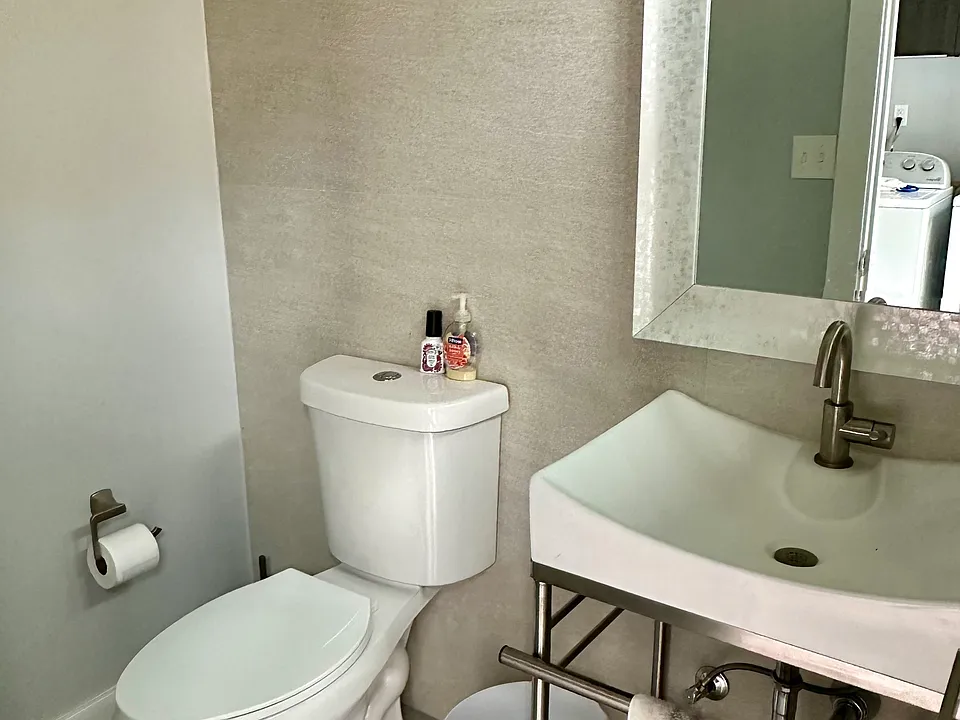 downstairs half bathroom with easy access to the backyard for guests