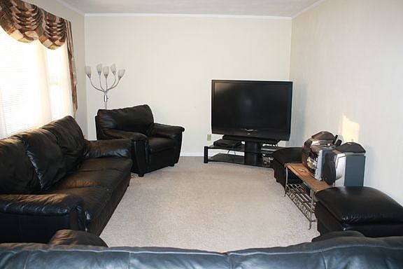 Living room freshly painted with custom made drapes.