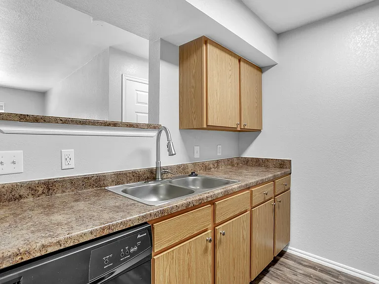 Modern kitchen with sleek countertops, double sink, and elegant wooden cabinetry, offering a spacious and functional design. Modern kitchen with sleek countertops, double sink, and elegant wooden cabinetry, offering a spacious and functional design.