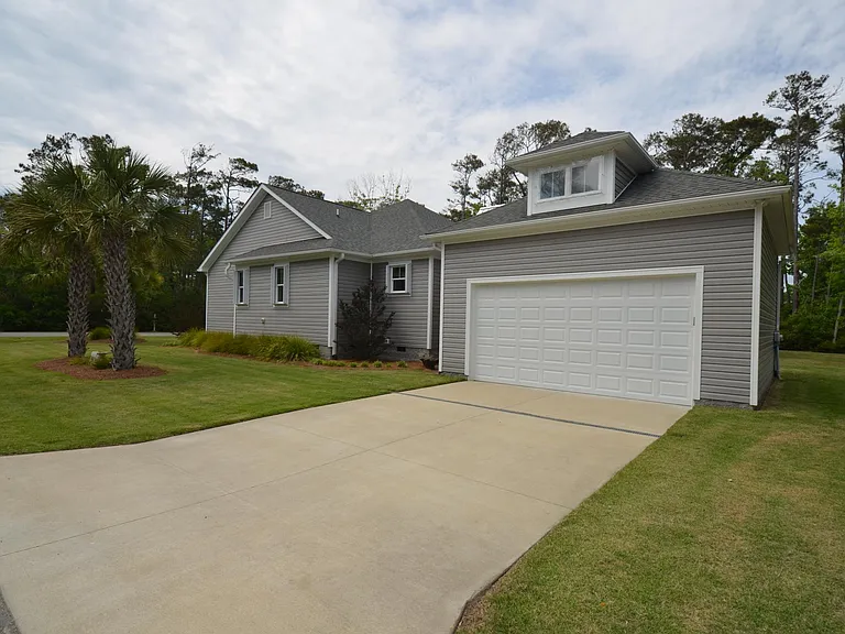 RARE finished two-car garage with epoxy flooring and Tesla charger.