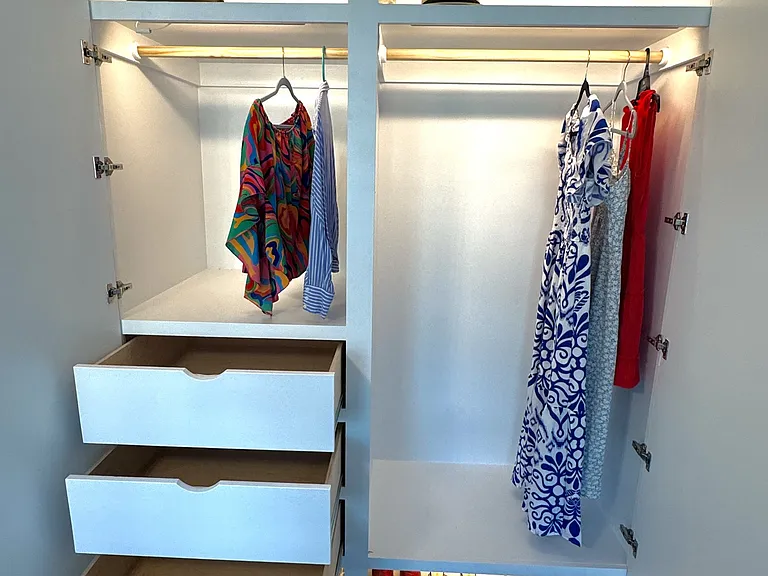 New custom oversized closet with double hanging section, upper shelf, deep drawers, shoe shelf, and motion lighting.