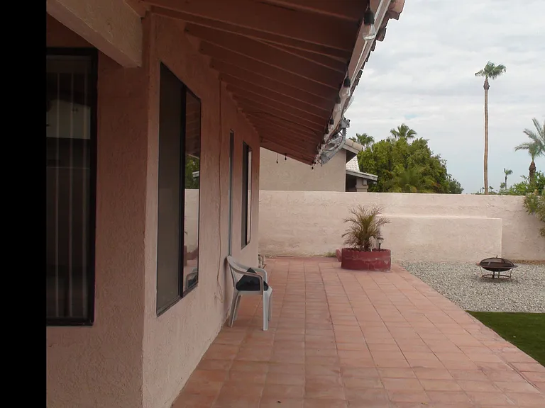 Nice long back porch with some shelter from the eves. Tile decking
