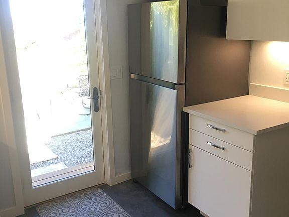 Full-size, stainless steel refrigerator.