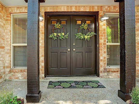 Double door entry to the beautiful home with porch