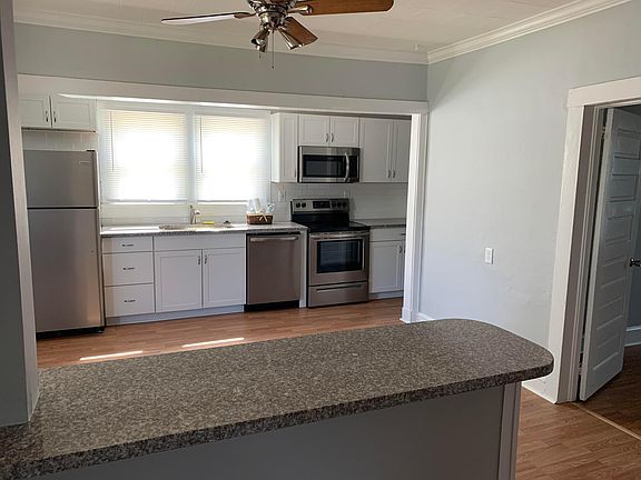 New kitchen with granite countertops and stainless steel appliances.