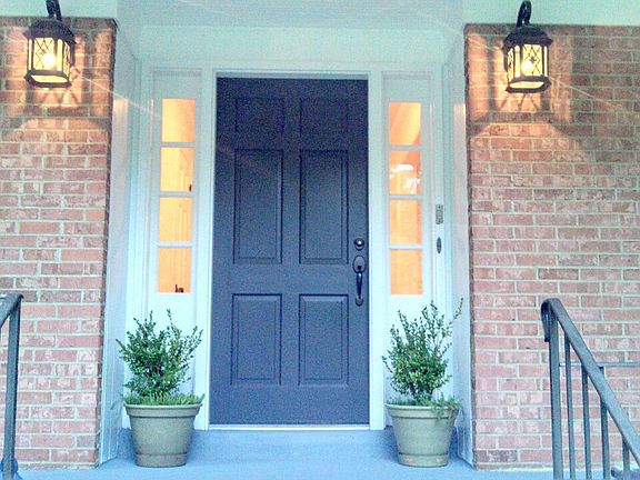Front door with dual side lights, new light fixtures, inviting!