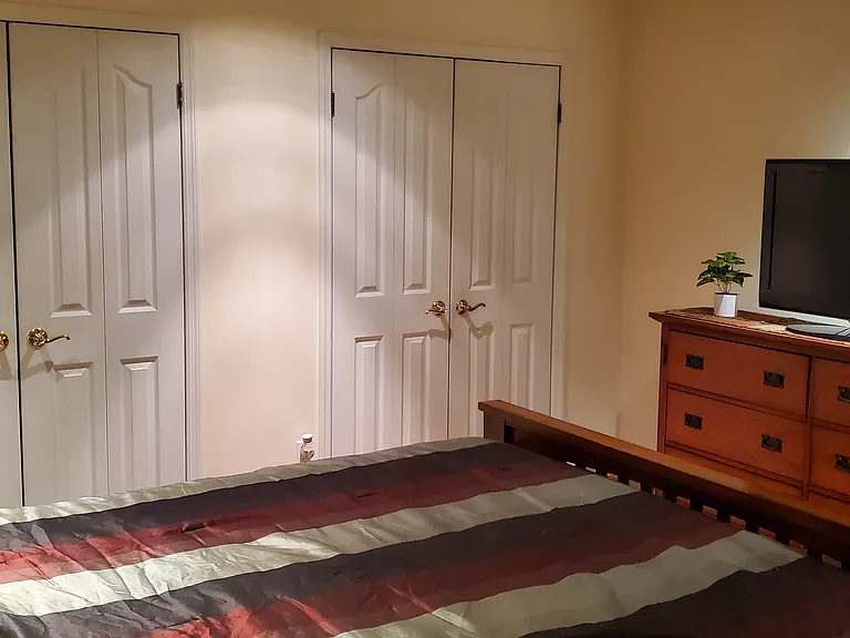Primary bedroom with an entire wall of closets