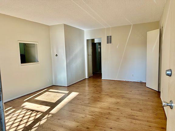 Spacious living room, connects to the open dining area and large outdoor patio.