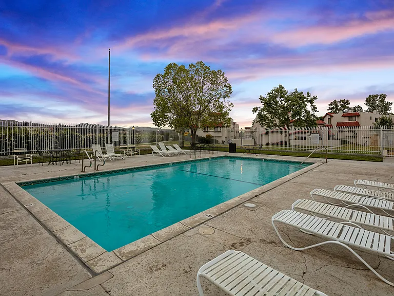Slip into the cool embrace of the pool's depths or bask in the sunshine on comfortable lounge chairs lining the poolside.
As the day transitions into evening, the pool area transforms into a magical setting, with underwater lights casting a soft, inviting