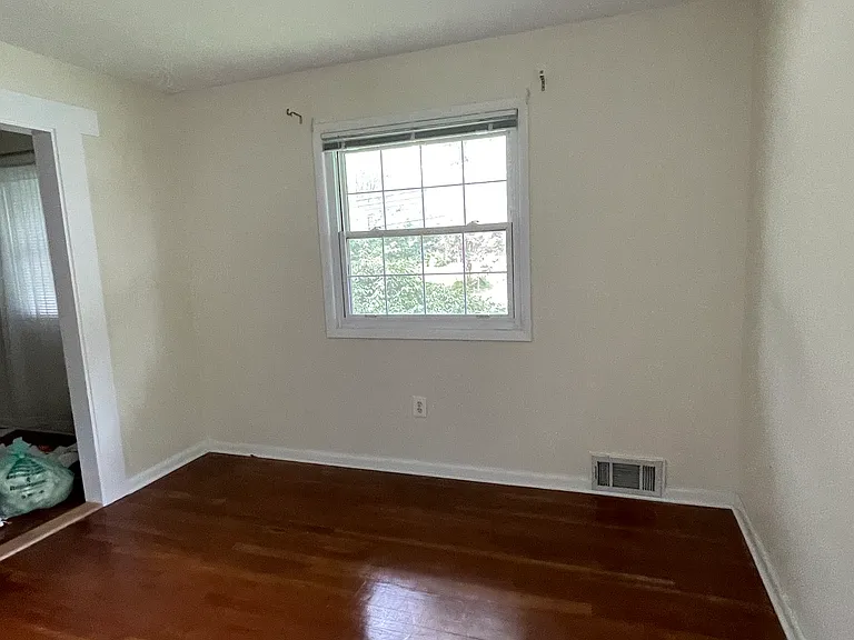 2nd room. One window. Arch on left