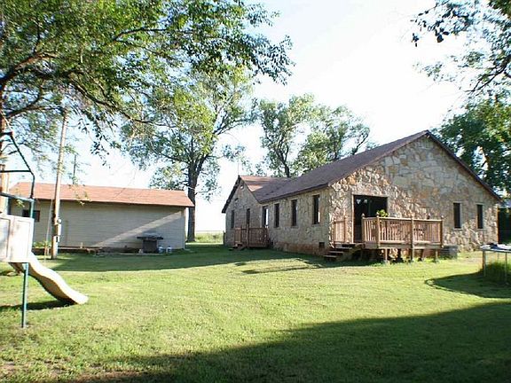 Back of House. Garage on Left Side
						:
						Hand laid stone. New in 2008.
Back yard is fenced.