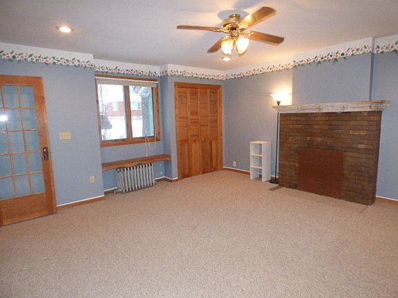 The master bedroom, is just off the living room. Fireplace has been closed off for rental purposes.