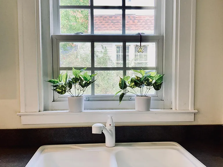 View of the kitchen sink with window facing the side of the house.
