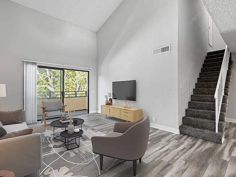 Hardwood floor living room with view of loft staircase.