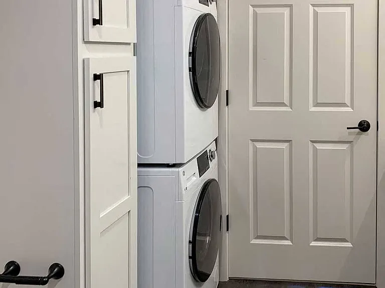 Tucked-away stackable washer and dryer add convenience and functionality to your home.