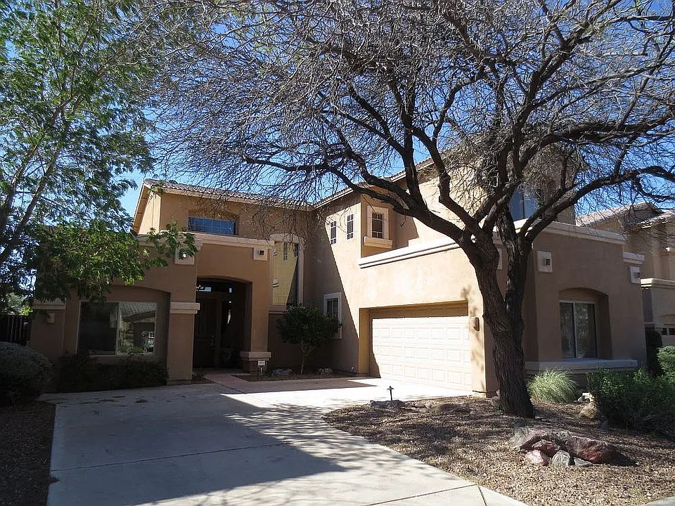 Exterior with 2 car garage and mature trees