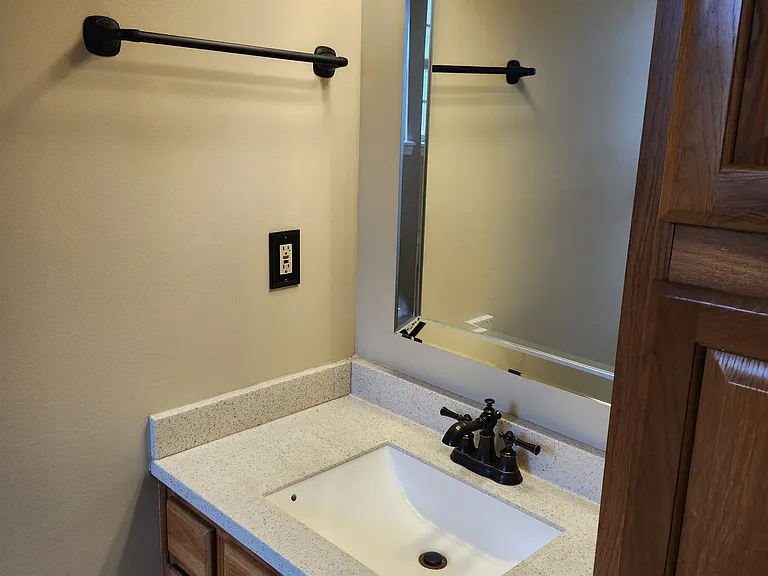 Close-up view of each vanity. Nice bronze hardware creating a modern look.