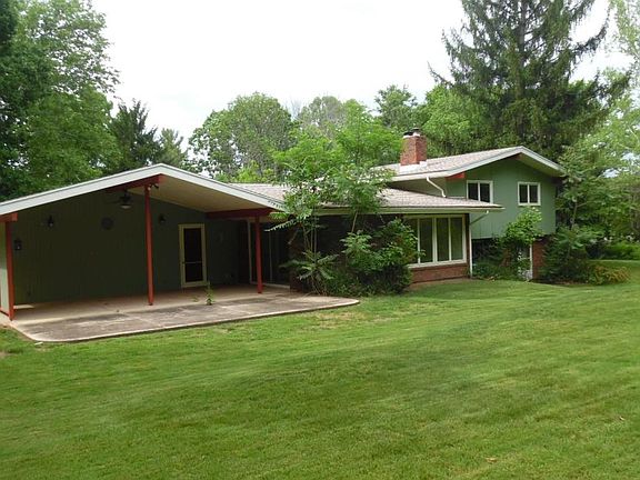 Lovely backyard surrounded by trees.