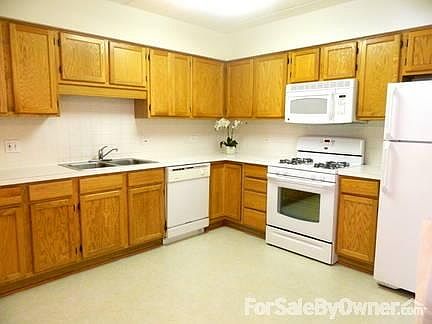 Large Eat-in Kithchen
						:
						Spacious eat-in kitchen with full cabinets, appliances, and new flooring.