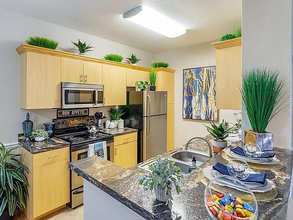 Premium kitchens feature granite-style counter tops, ample cabinet space, and stainless steel appliances.